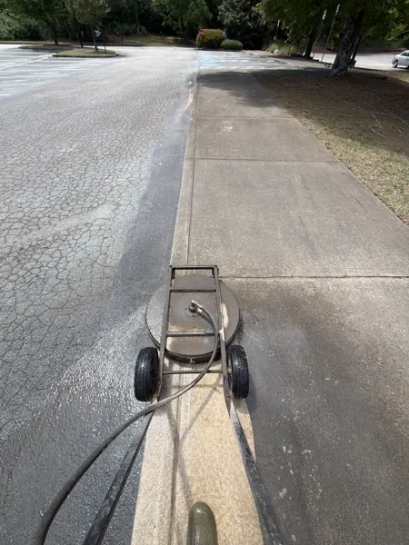 Surface cleaner washing a concrete driveway
