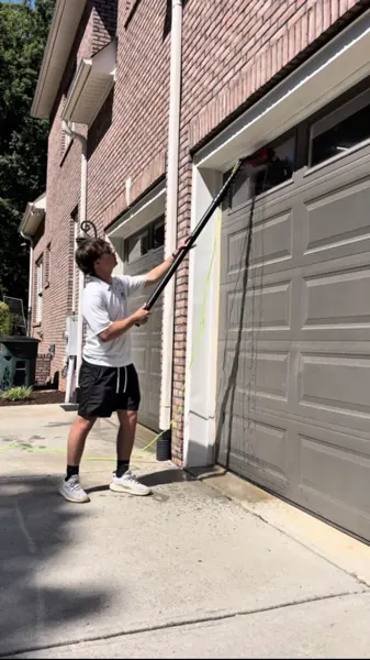 Washing the exterior above a garage door