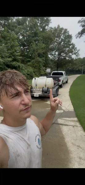 Living Water Washing team member with the work trailer