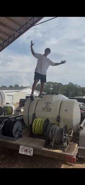 Team member standing on the washing equipment trailer