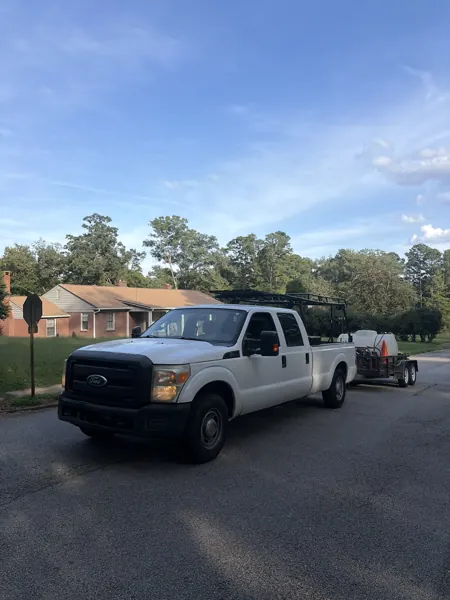 Work truck and pressure washing trailer on a residential street