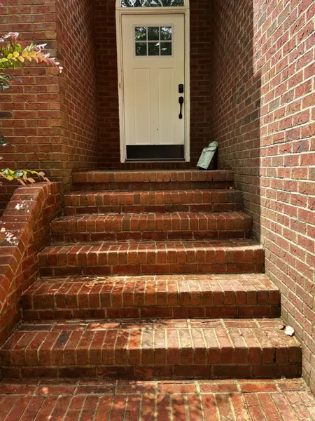 Brick entry steps and walkway outside a home